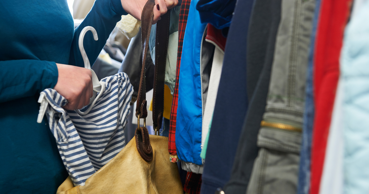 a person stealing a t-shirt from a clothing store